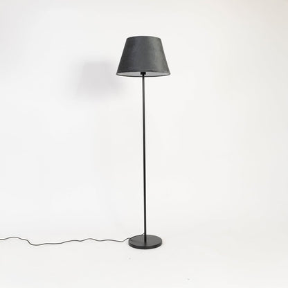 Modern black shade floor lamp with slim metal stand shown switched off on white backdrop.