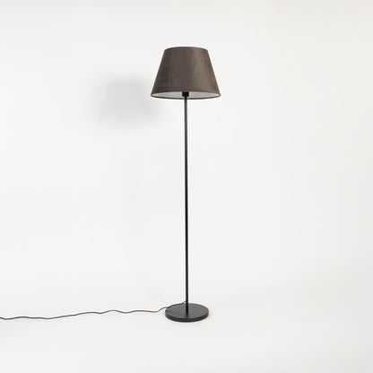 Modern brown shade floor lamp with slim black stand shown switched off on plain white background.