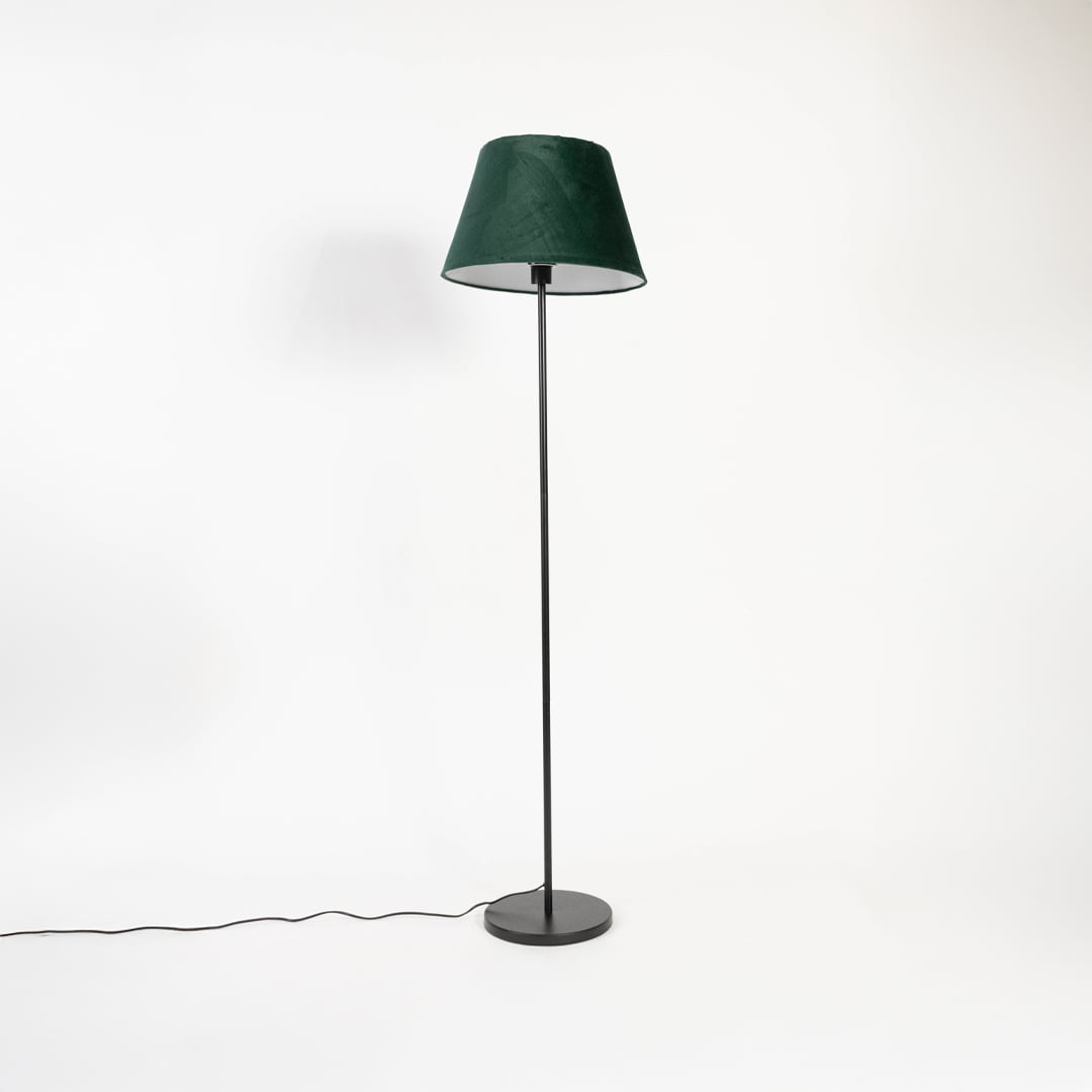 Dark green fabric shade floor lamp with slim black stand displayed switched off on white background.