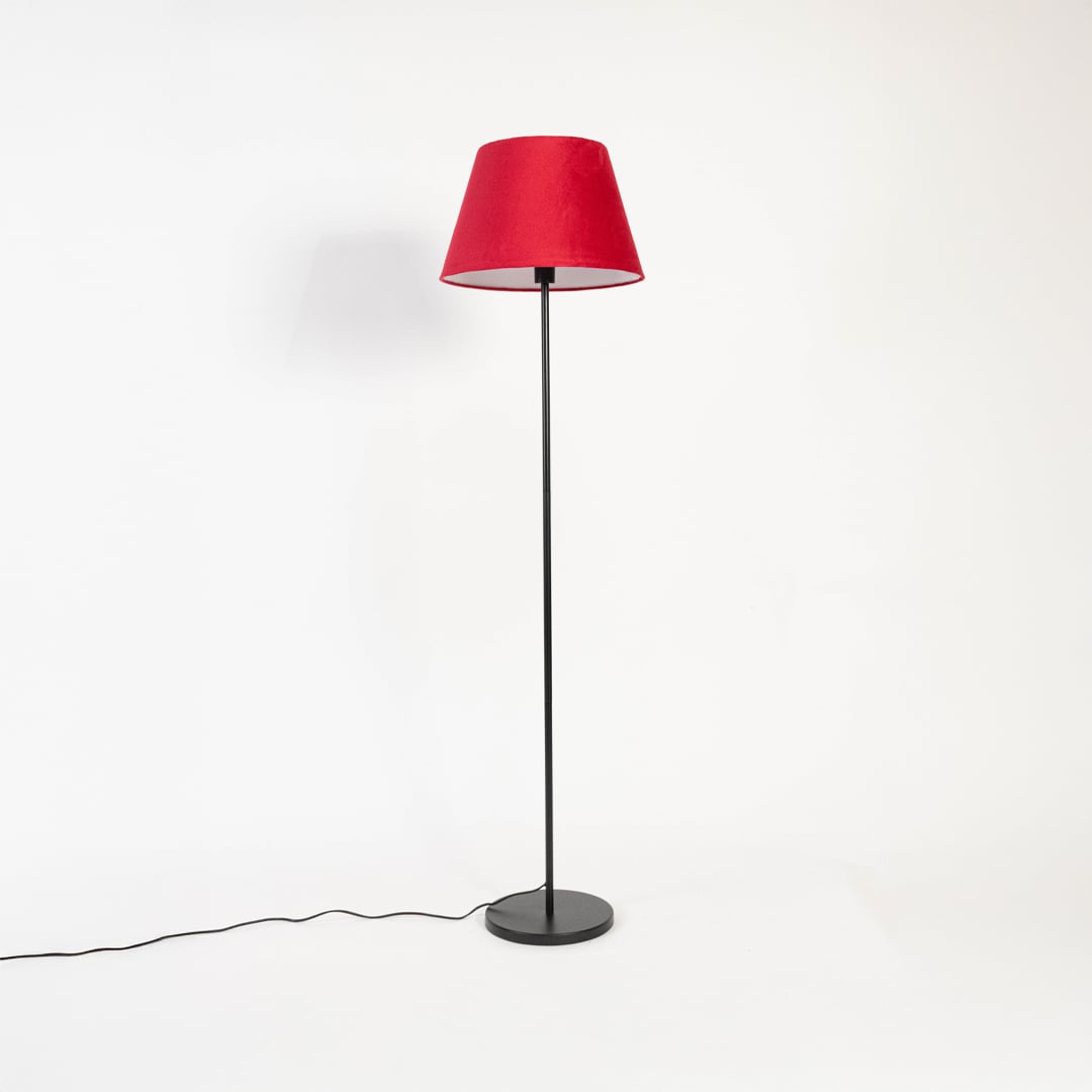 Modern red shade floor lamp with slim black metal stand shown switched off on white backdrop.