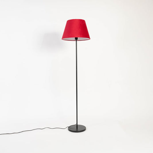 Modern red shade floor lamp with slim black metal stand shown switched off on white backdrop.