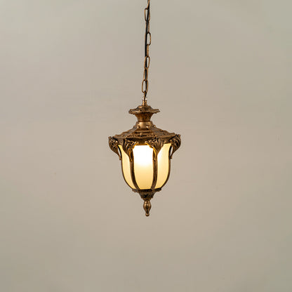 Gold metal hanging outdoor lantern with glass panels glowing on white background perfect for gate entrance and exterior decor lighting.