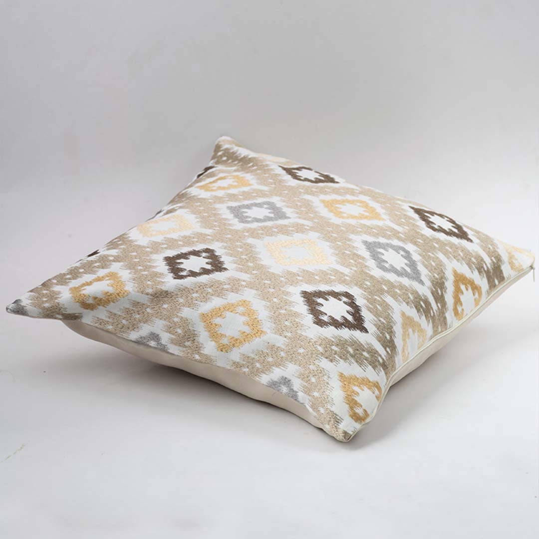 Decorative cushion on white background showcasing a square pillow with geometric pattern in soft neutral tones for modern home styling.