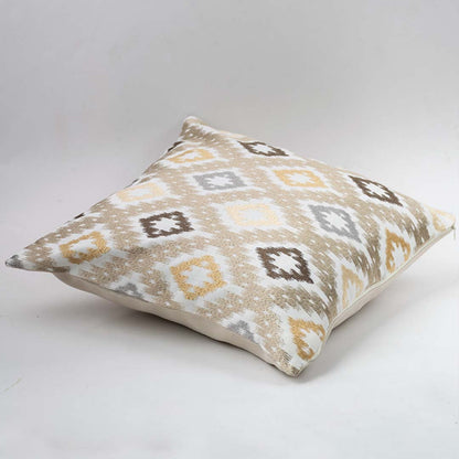 Decorative cushion on white background showcasing a square pillow with geometric pattern in soft neutral tones for modern home styling.