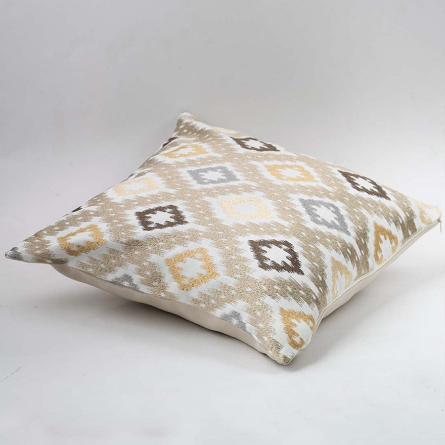 Decorative cushion on white background showcasing a square pillow with geometric pattern in soft neutral tones for modern home styling.
