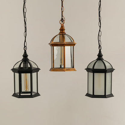 Grouped hanging lanterns with light off showing bronze and black frames dome tops and clear glass panels suitable for classic themed outdoor decor.