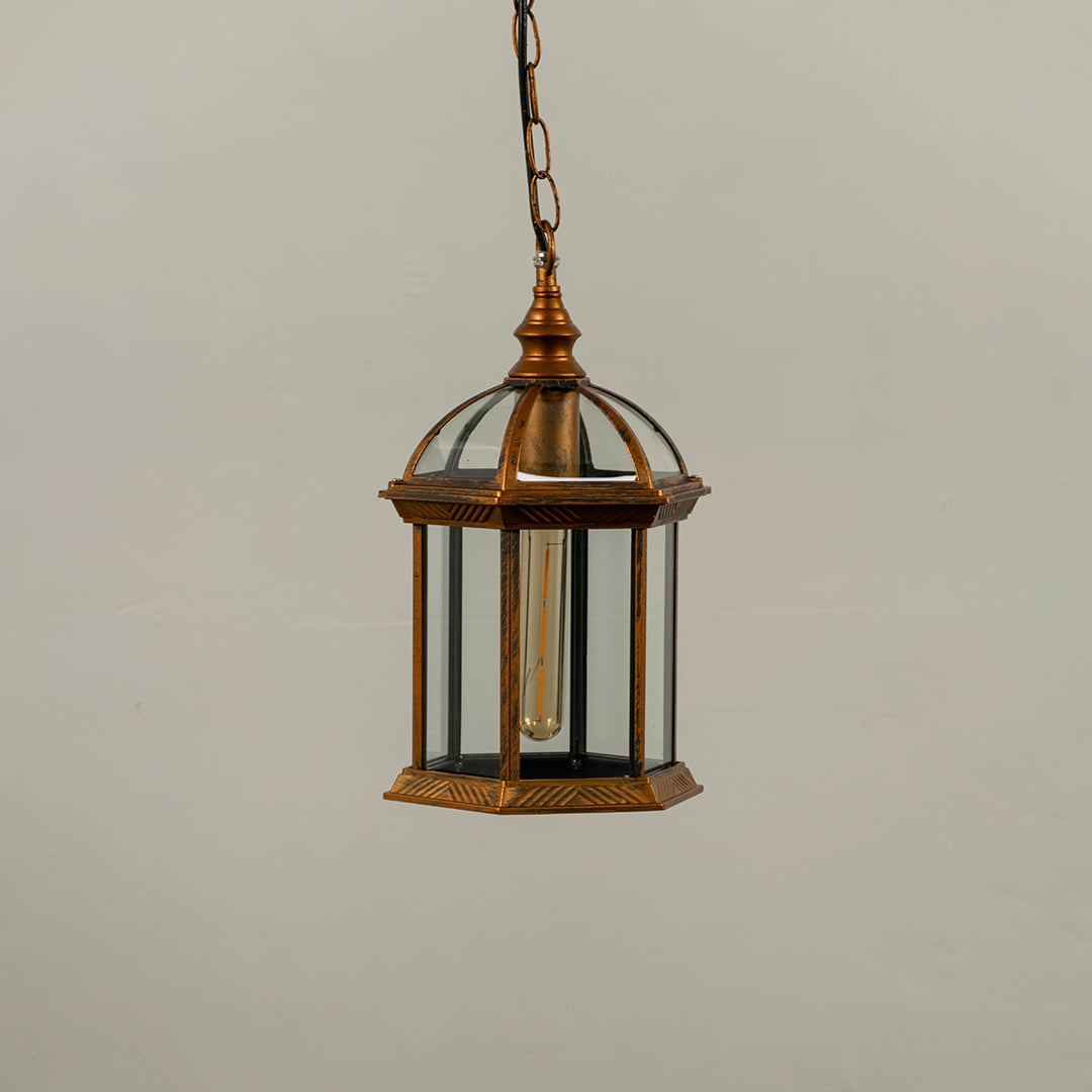 Bronze vintage hanging lantern on white background with light off highlighting clear glass panels dome top structure and classic hexagonal frame.