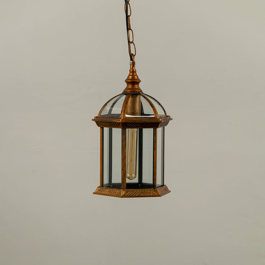 Bronze vintage hanging lantern on white background with light off highlighting clear glass panels dome top structure and classic hexagonal frame.
