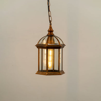 Bronze hanging outdoor lantern on white background with light on displaying warm illumination through clear glass panels and vintage dome top design.