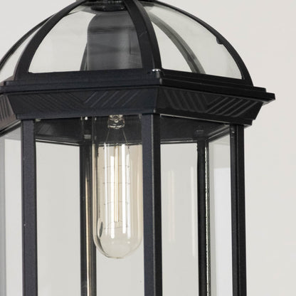 Black outdoor hanging lantern light glowing softly on white background showing detailed metal finish.