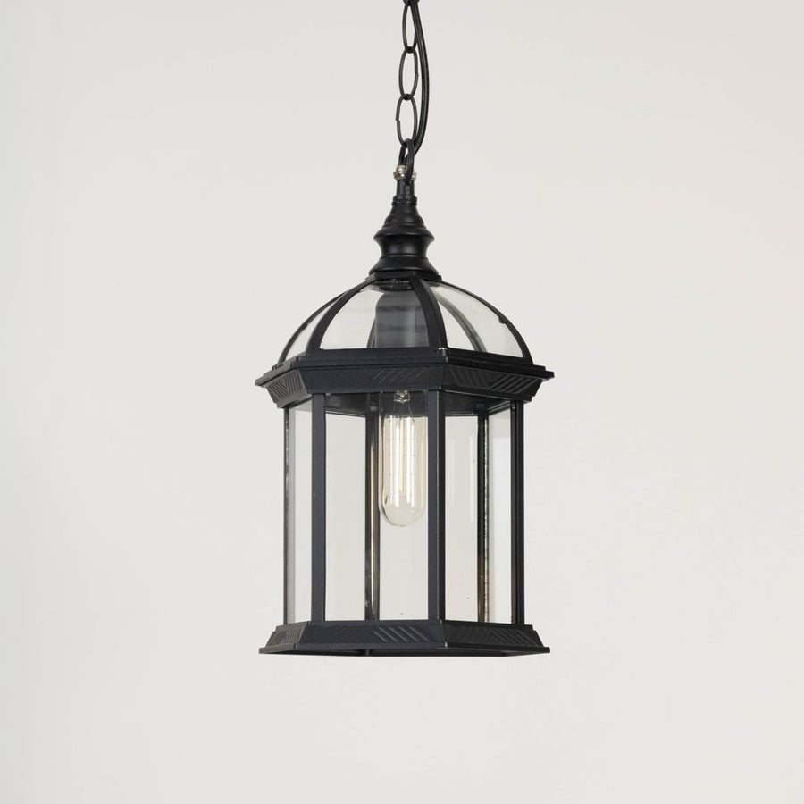 Black outdoor lantern light turned off on white background displaying modern dome design and clarity.