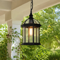 Black metal and glass outdoor hanging lantern for porch entrance patio and covered balcony with warm ambient lighting.