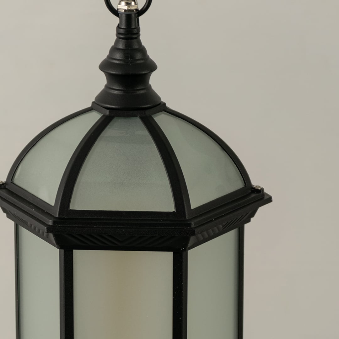 Detailed view of black dome shaped lantern with light off highlighting frosted glass finish and sturdy metal frame for durable exterior lighting decor.