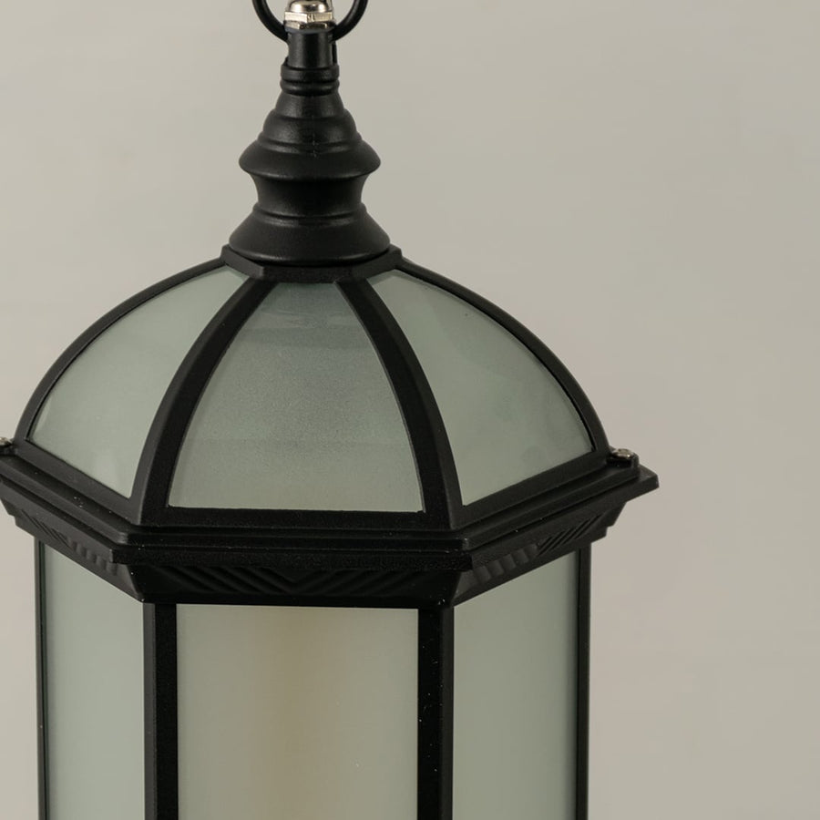 Detailed view of black dome shaped lantern with light off highlighting frosted glass finish and sturdy metal frame for durable exterior lighting decor.