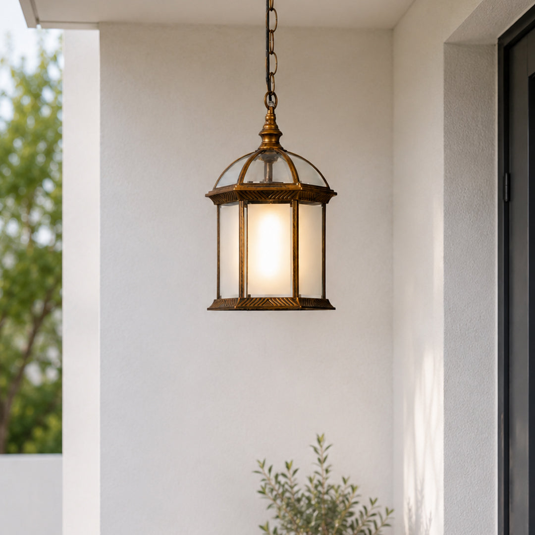 Vintage brass metal outdoor hanging lantern for porch entrance balcony and covered patio with warm ambient lighting.