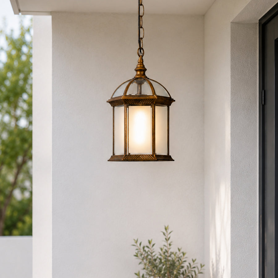 Vintage brass metal outdoor hanging lantern for porch entrance balcony and covered patio with warm ambient lighting.