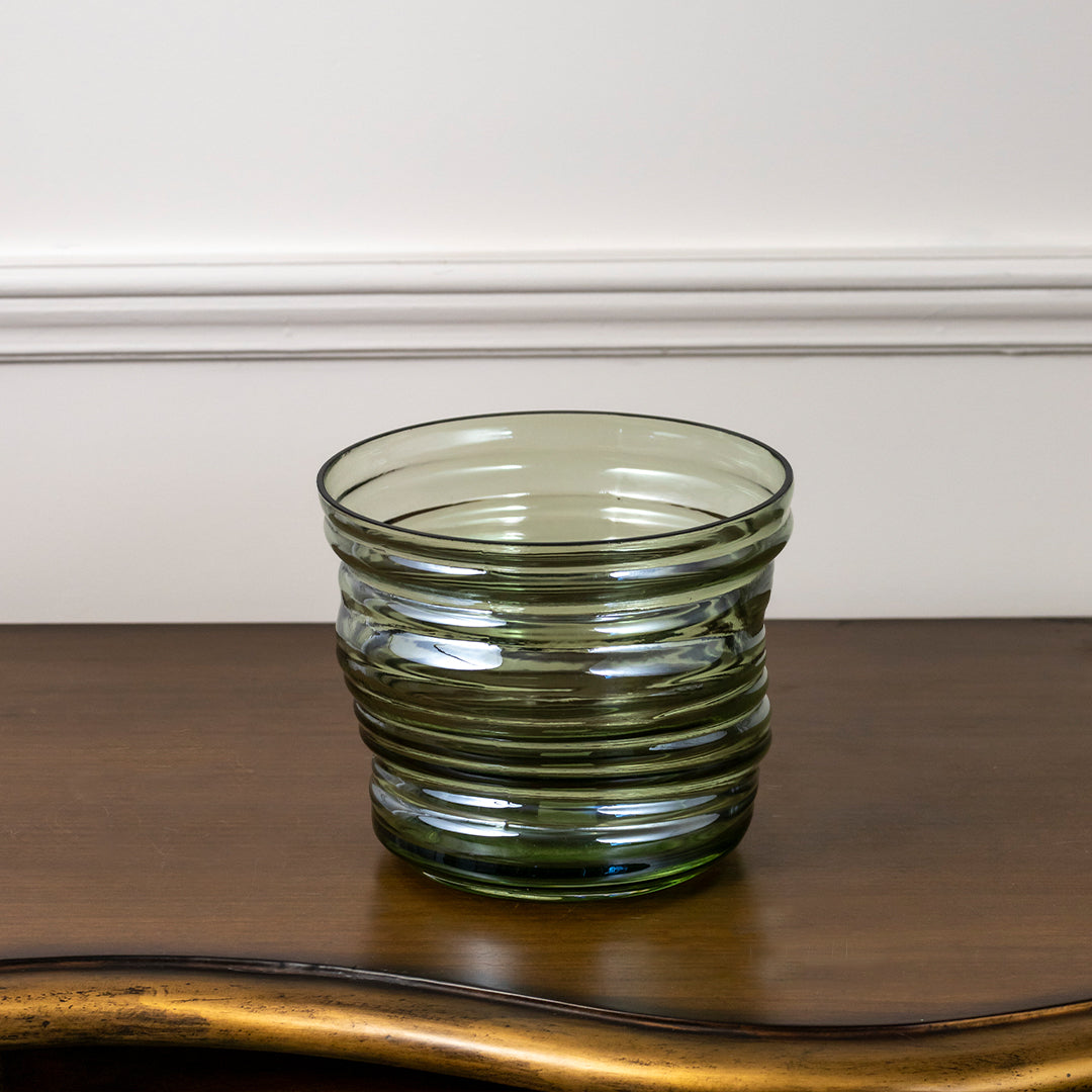 Small green ridged glass bowl for decorative table accents and elegant modern living room storage organization.
