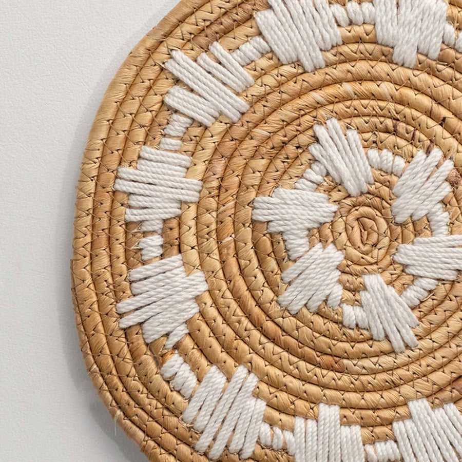 Handcrafted natural seagrass wall basket set with white sunburst pattern for boho living room wall décor styling.