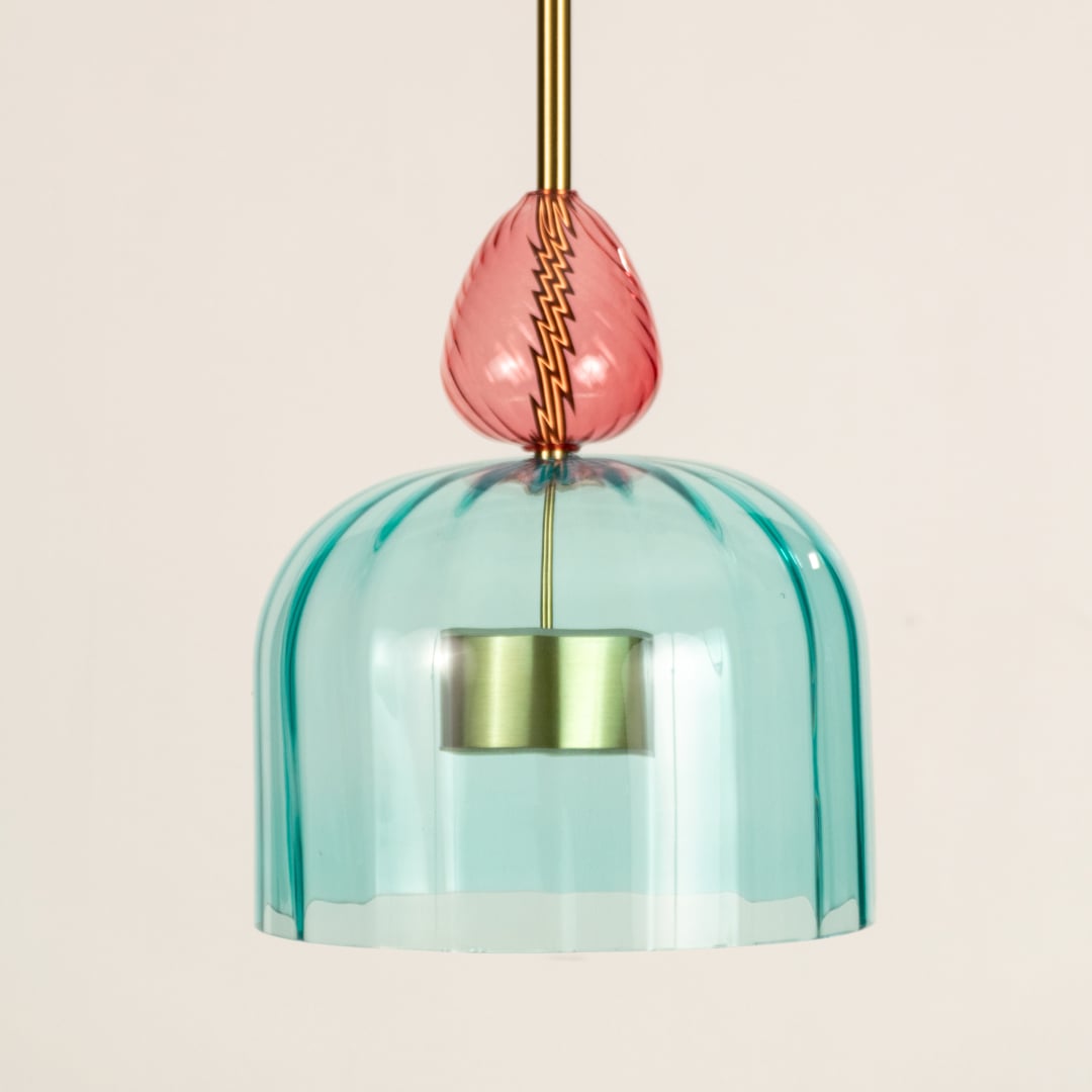 Closeup of turquoise textured glass pendant light with coral details highlighting artisan craftsmanship.