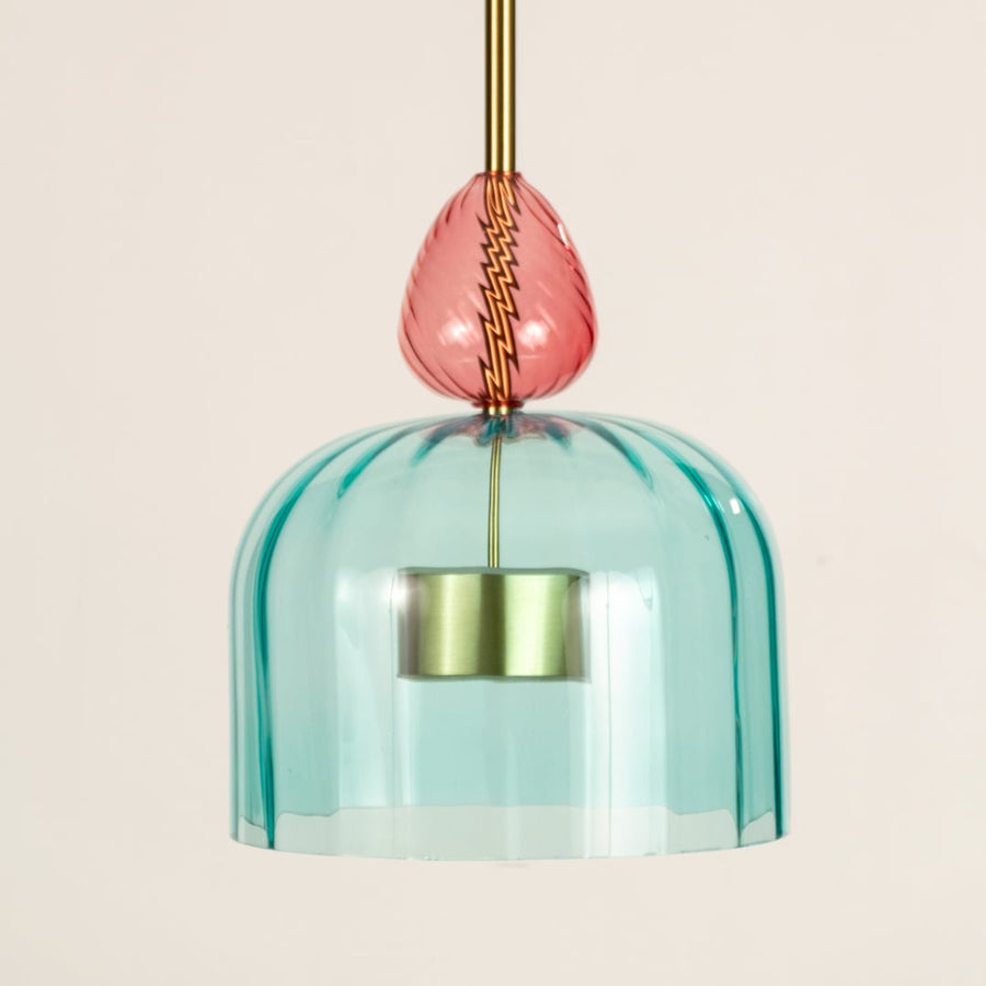 Closeup of turquoise textured glass pendant light with coral details highlighting artisan craftsmanship.