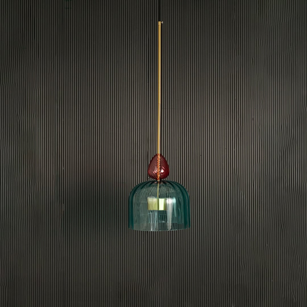 Turquoise glass pendant light with gold fittings showcasing artistic design for modern interiors.