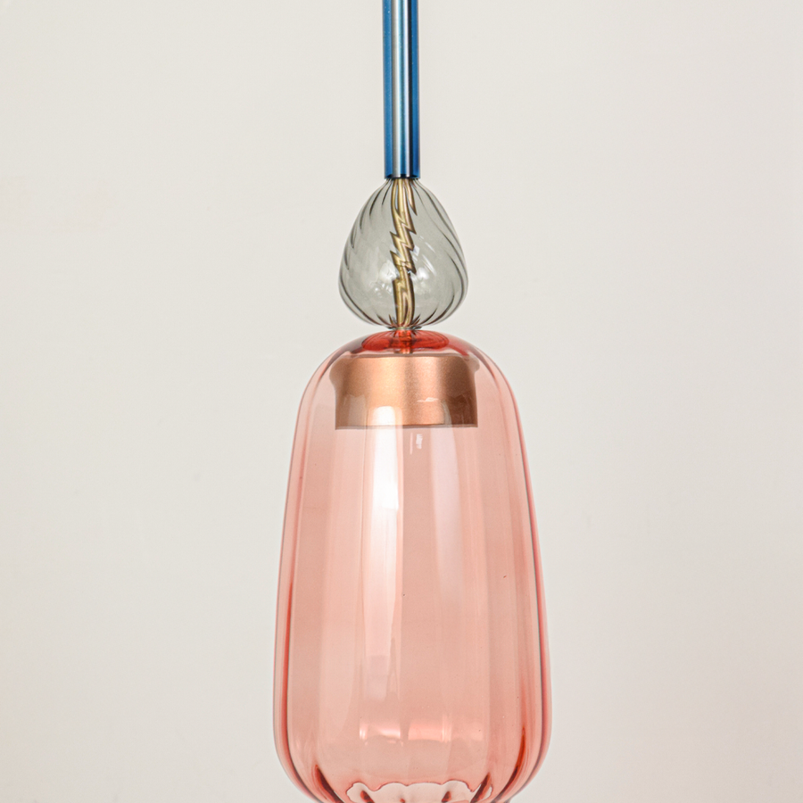 Detailed view of pink glass pendant light with transparent finish and refined decorative accents.