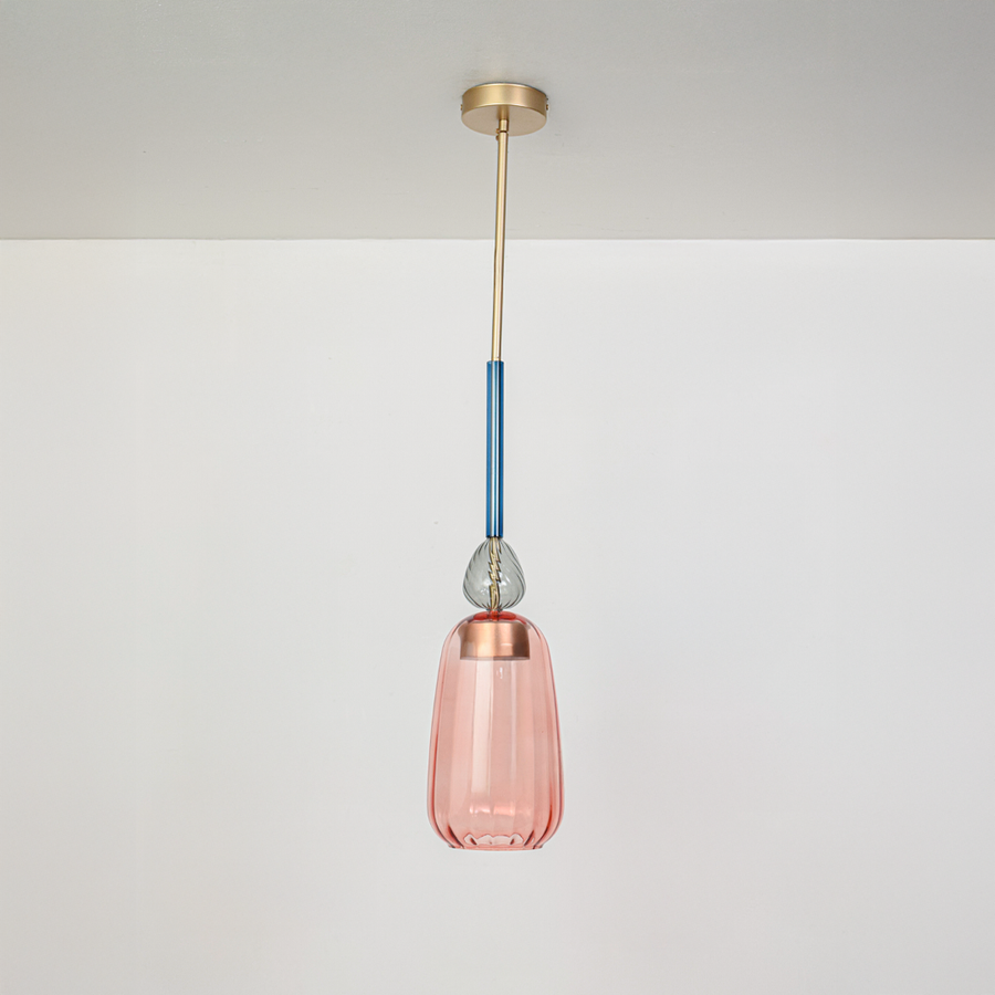 Pink glass pendant light with blue stem and gold fittings designed for contemporary interiors.