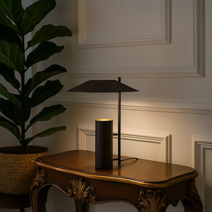 Dark brown metal table lamp with geometric shade adding modern elegance to tabletop decor in a stylish living room setting.
