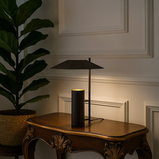 Dark brown metal table lamp with geometric shade adding modern elegance to tabletop decor in a stylish living room setting.