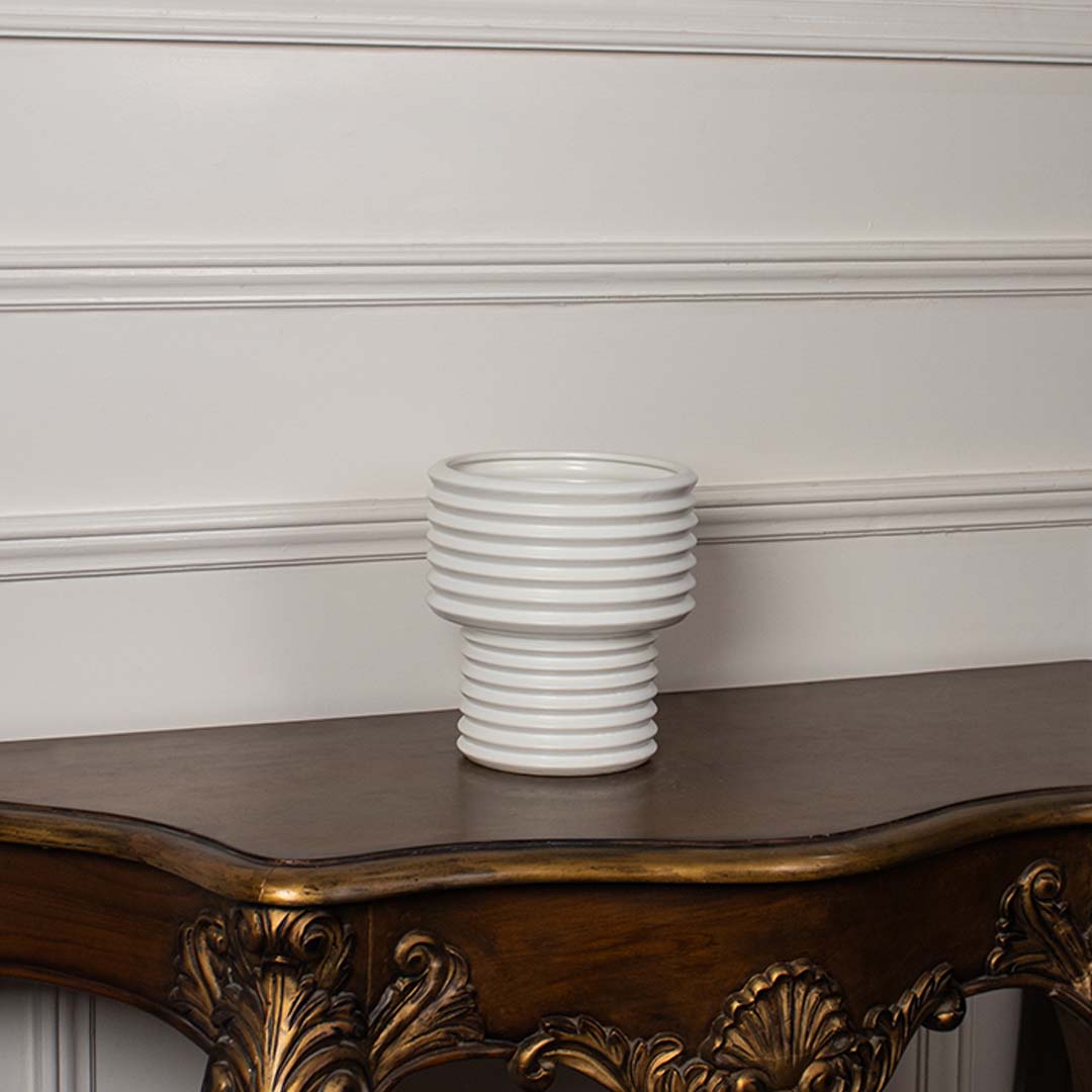 White ribbed ceramic vase displayed on a clean white background ideal for minimal home decor and contemporary tabletop styling.
