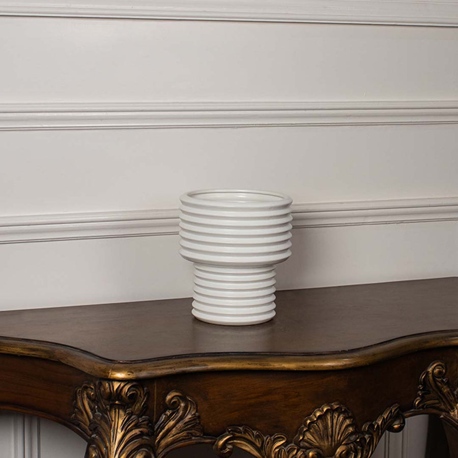 White ribbed ceramic vase displayed on a clean white background ideal for minimal home decor and contemporary tabletop styling.