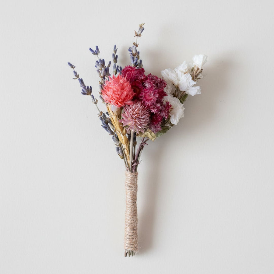 Dried floral stem bouquet with lavender wheat and pink blooms on white background highlighting layered textures handcrafted charm and decor appeal.