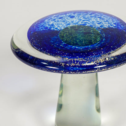 Close up view blue art glass mushroom decor object showing glossy texture handmade glass finish luxury accent for shelf styling home.