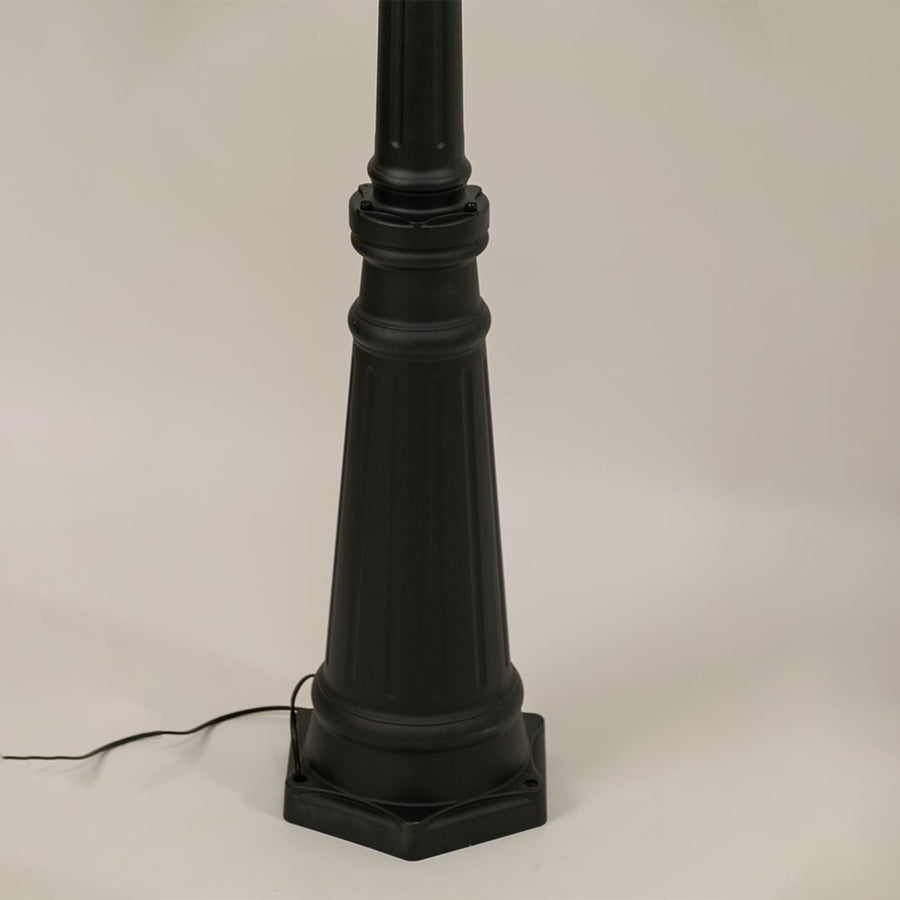 Detailed closeup of black metal outdoor lantern top with ribbed glass and warm design features ideal for enhancing garden walkway and home entrance Decor.