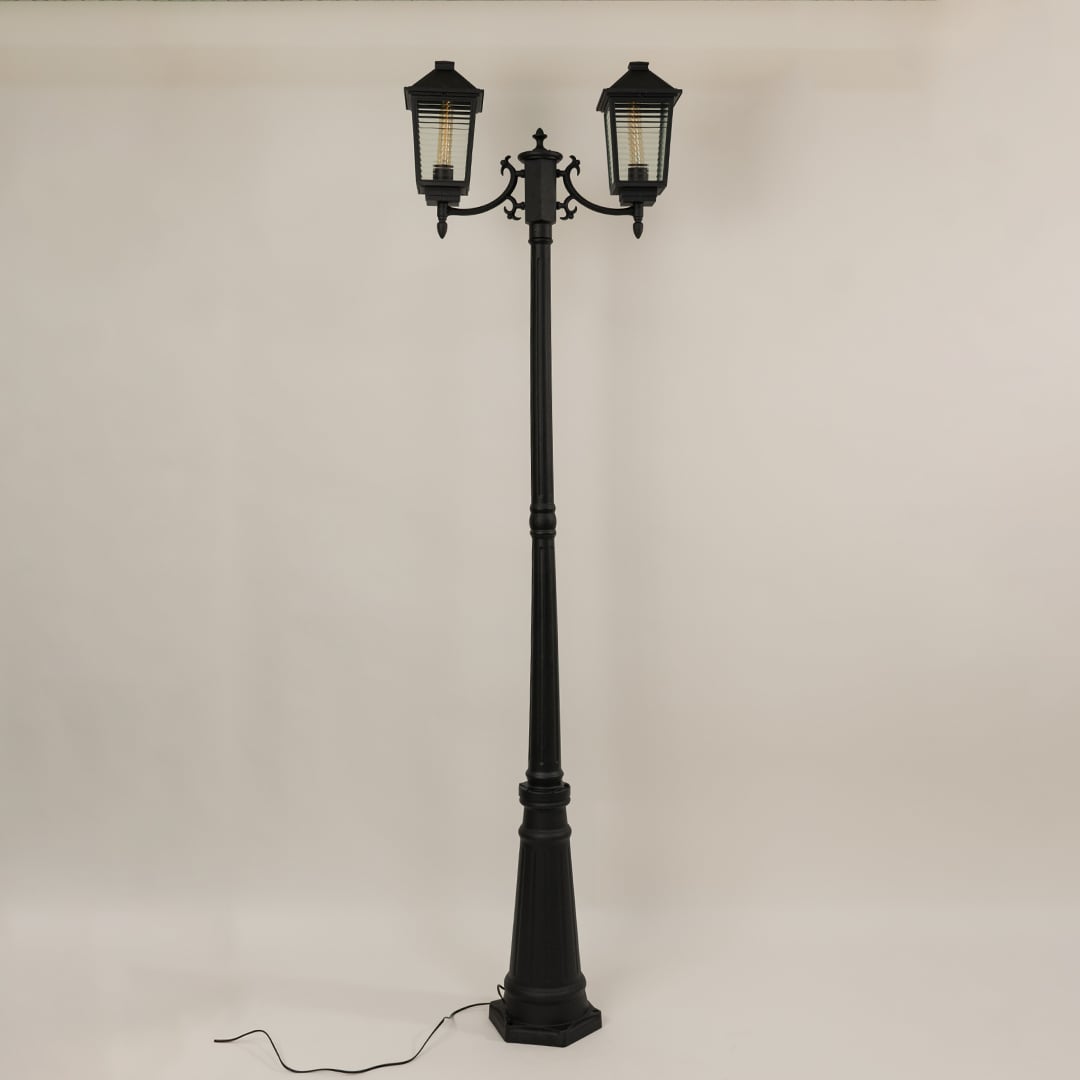 Black metal dual lantern outdoor lamp post light off highlighting classic frame structure and ribbed glass ideal for garden walkway and driveway Decor.