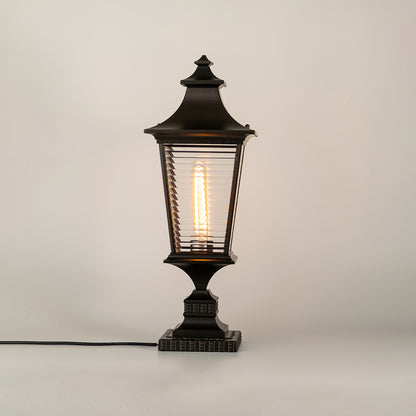 Vintage black outdoor gate light with glowing bulb for elegant exterior decor styling use.