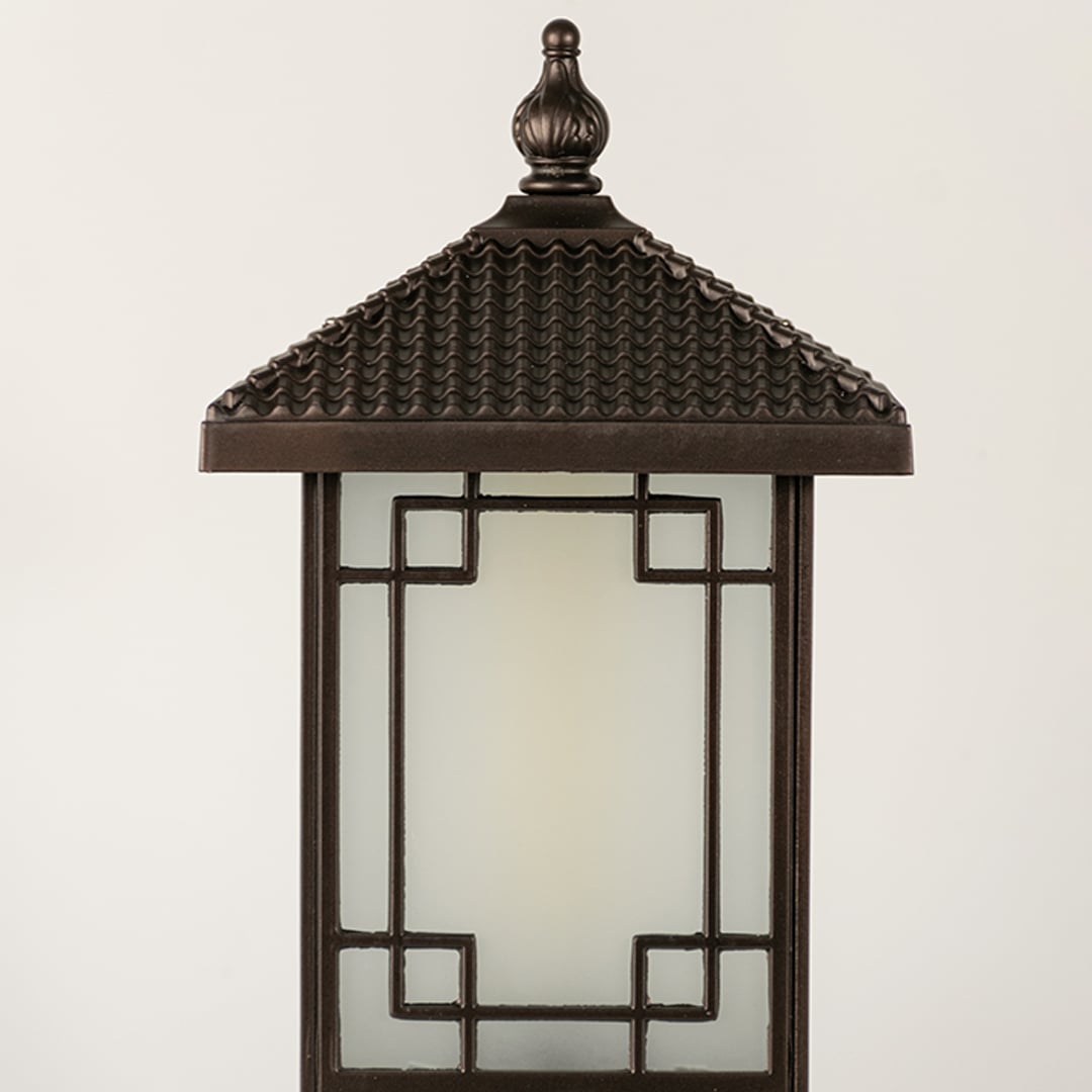 Black outdoor lantern Closeup seeded glass Light On showing the warm ambient glow and decorative pebbled glass panels detail.