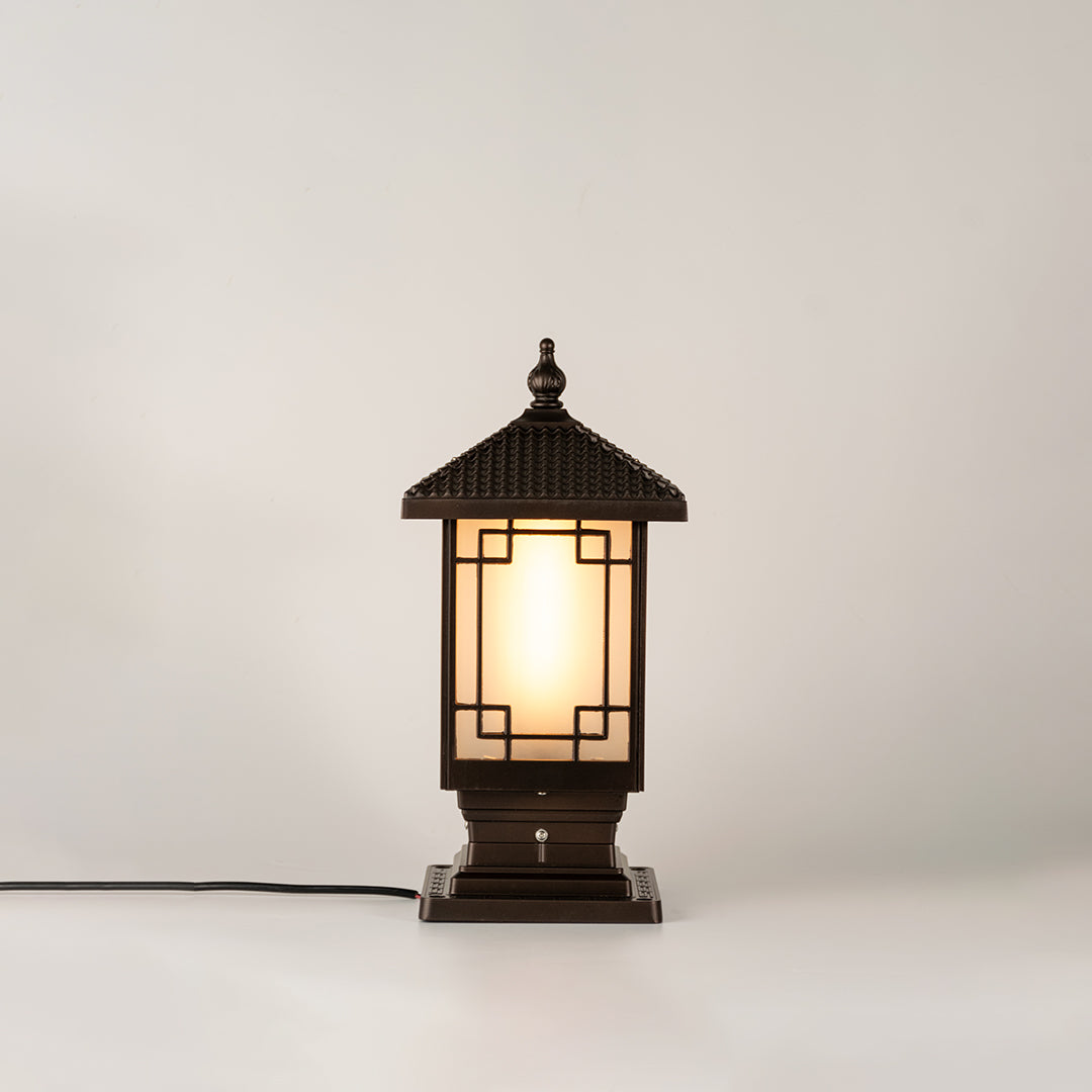 Vintage black outdoor gate light with warm ambient glow for luxury exterior decor styling use.