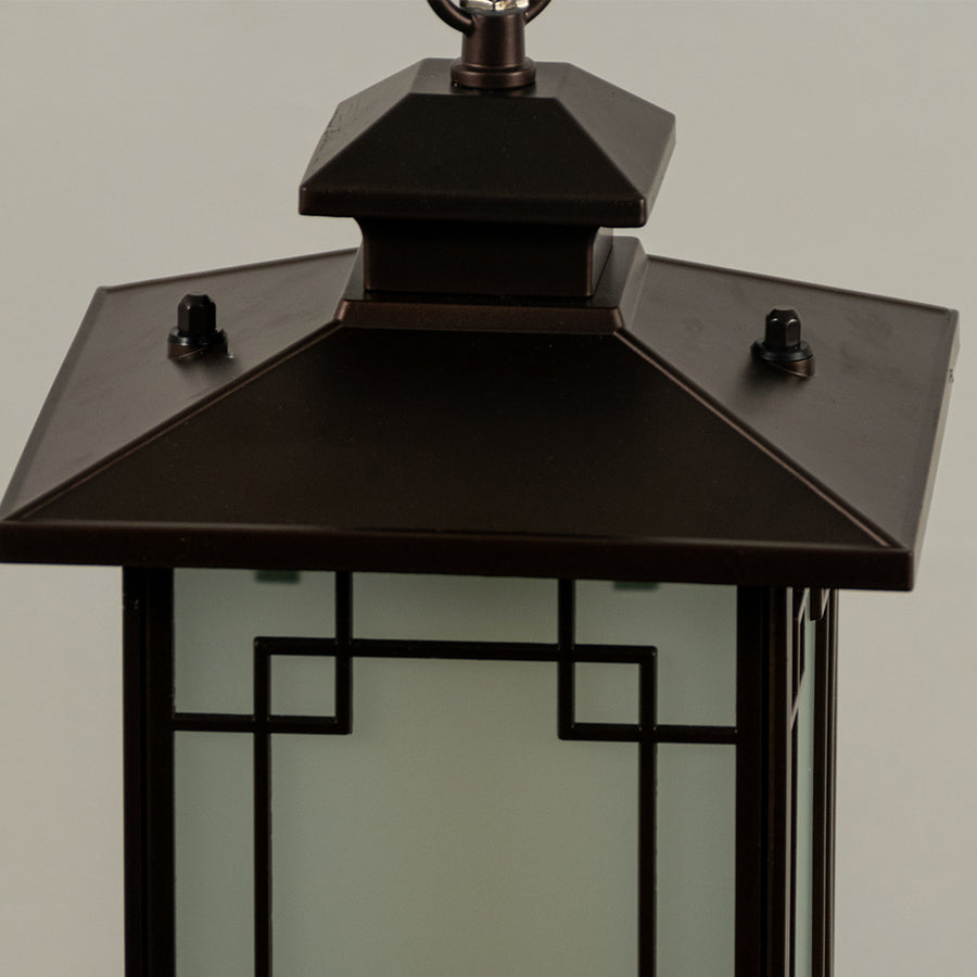 Closeup of black metal outdoor lantern with glass panels on white background ideal for gate entrance and exterior decor lighting.