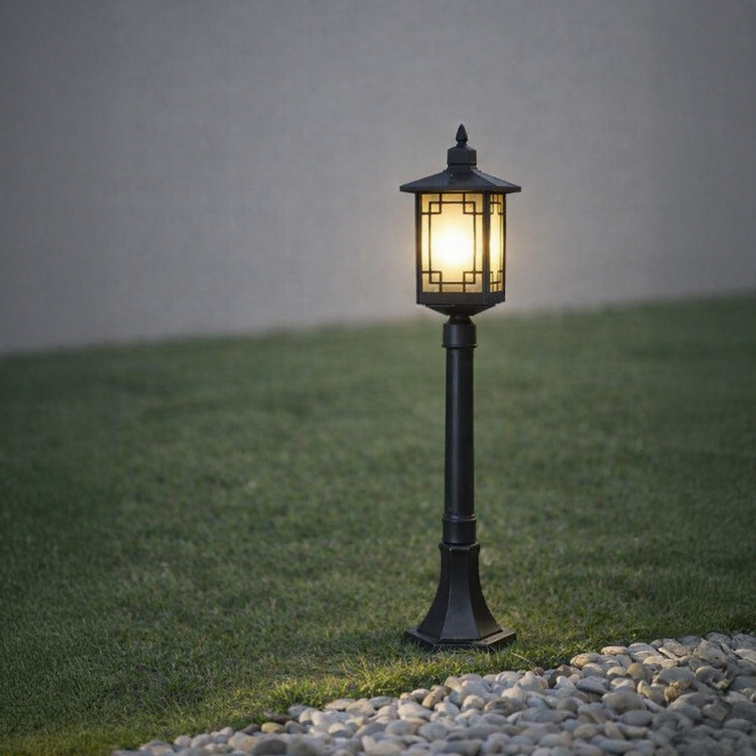 Black outdoor garden light with warm glowing panels for elegant pathway decor ambiance.