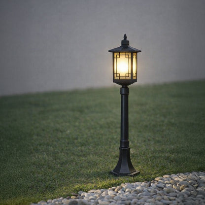 Black outdoor garden light with warm glowing panels for elegant pathway decor ambiance.