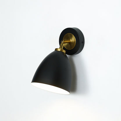Modern black and gold metal wall light mounted on white wall for elegant bedroom hallway and living room decor.