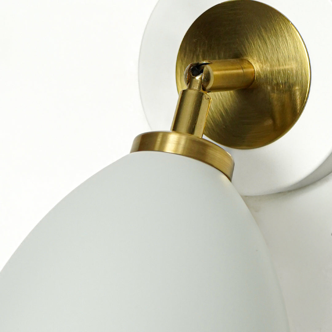 Closeup of white and gold metal wall light base for luxury bedroom hallway and modern interior decor styling.