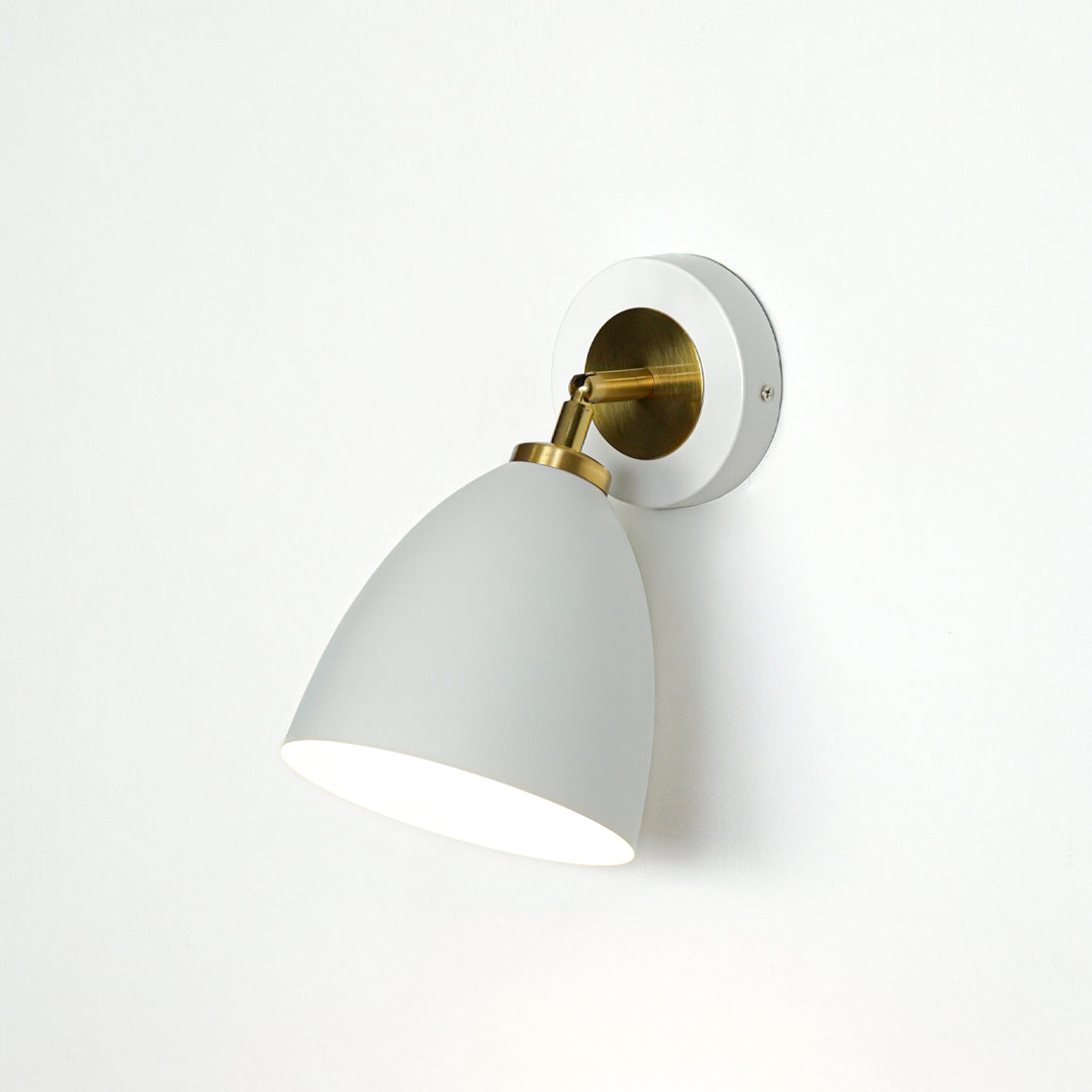 Modern white and gold metal wall light mounted on white wall for elegant bedroom hallway and living room decor.