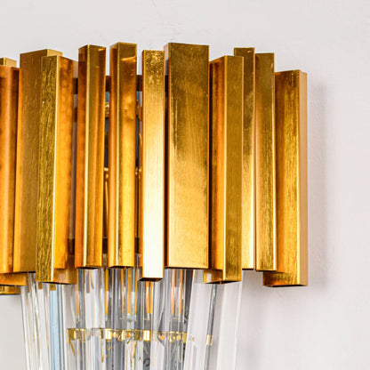 Closeup of cascade wall light featuring gold metal frame and crystal glass detailing showcasing sparkling texture for upscale wall decor.