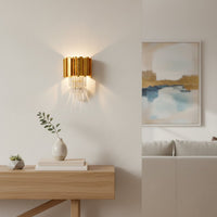 Gold metal and clear crystal wall light styled on feature wall creating elegant ambient lighting for luxury modern interiors.