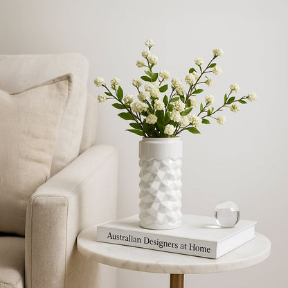 White textured ceramic vase styled in a soft minimal setting adding a modern accent to shelves and tables for elegant home decor.