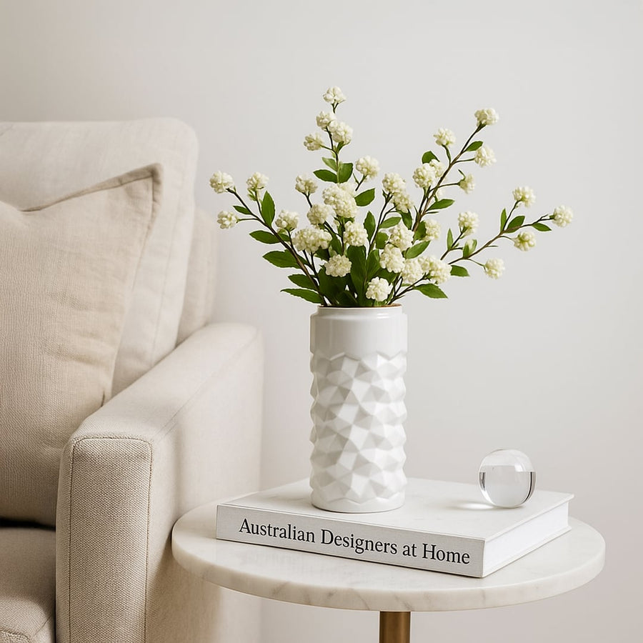 White textured ceramic vase styled in a soft minimal setting adding a modern accent to shelves and tables for elegant home decor.
