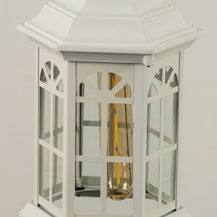 Closeup of white metal hanging outdoor lantern with glass panels on white background ideal for gate entrance and exterior decor lighting.