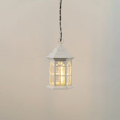 White hanging lantern on white background with light on showing warm glowing bulb inside clear glass panels and a classic hexagonal frame ideal for porch lighting.